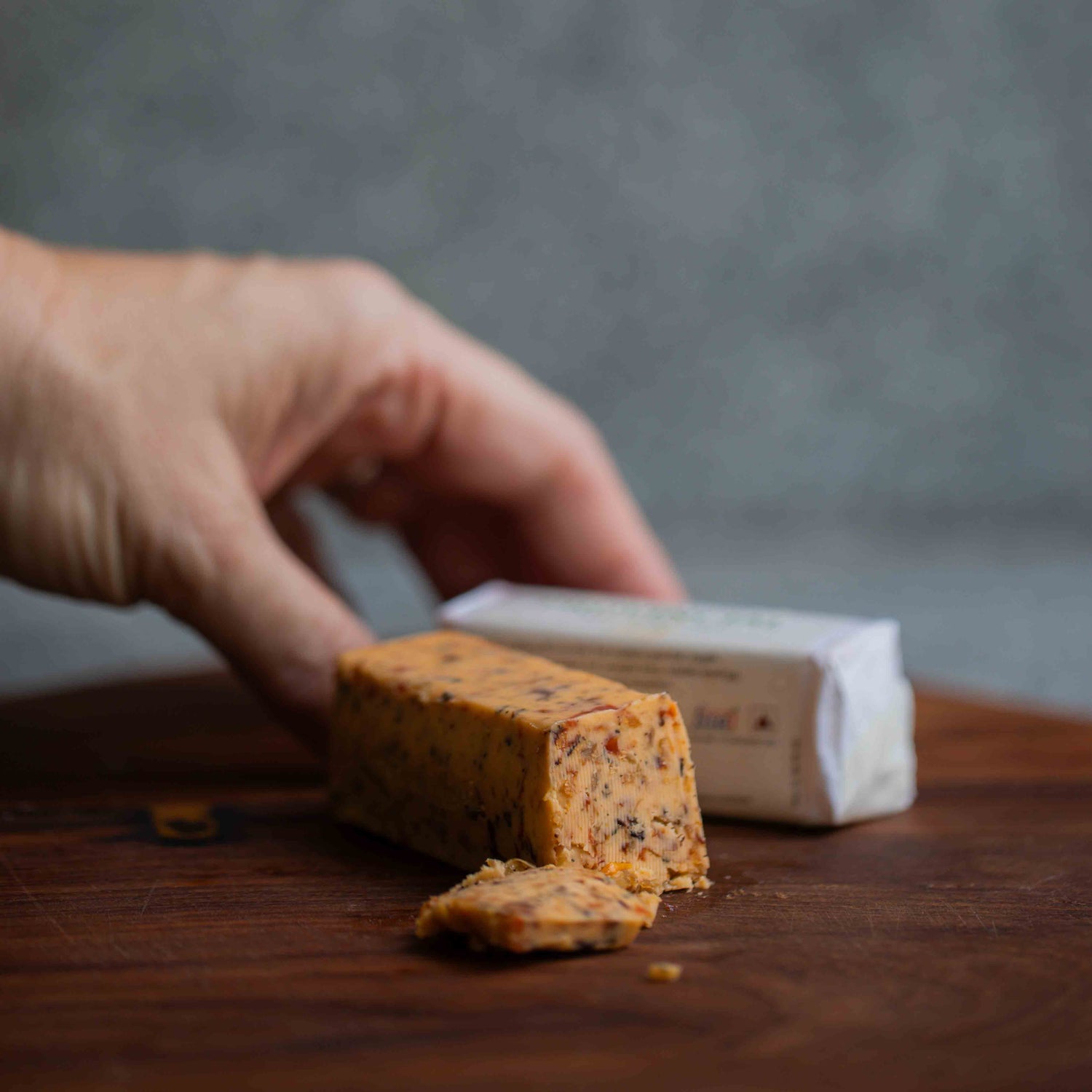 Hand holding the provincial snacking butter with chicken, tomato and thyme — savoury keto compound butter, no seed oils, made in Bangalore by The Larder