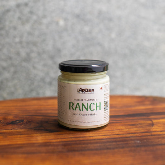 A glass jar with black lid of ranch dressing
